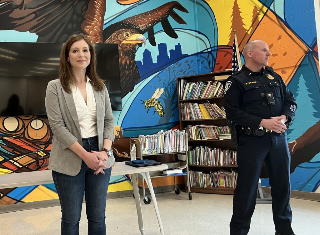 Rachel standing with a police officer at a Beechwood neighborhood forum